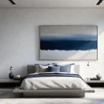 A serene minimalist bedroom with white walls a low platform bed andfeat