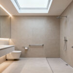 A modern, universally designed bathroom interior with a curbless shower, subtly integrated grab bars, and bright, glare-free lighting, illustrating an accessibility audit in progress.