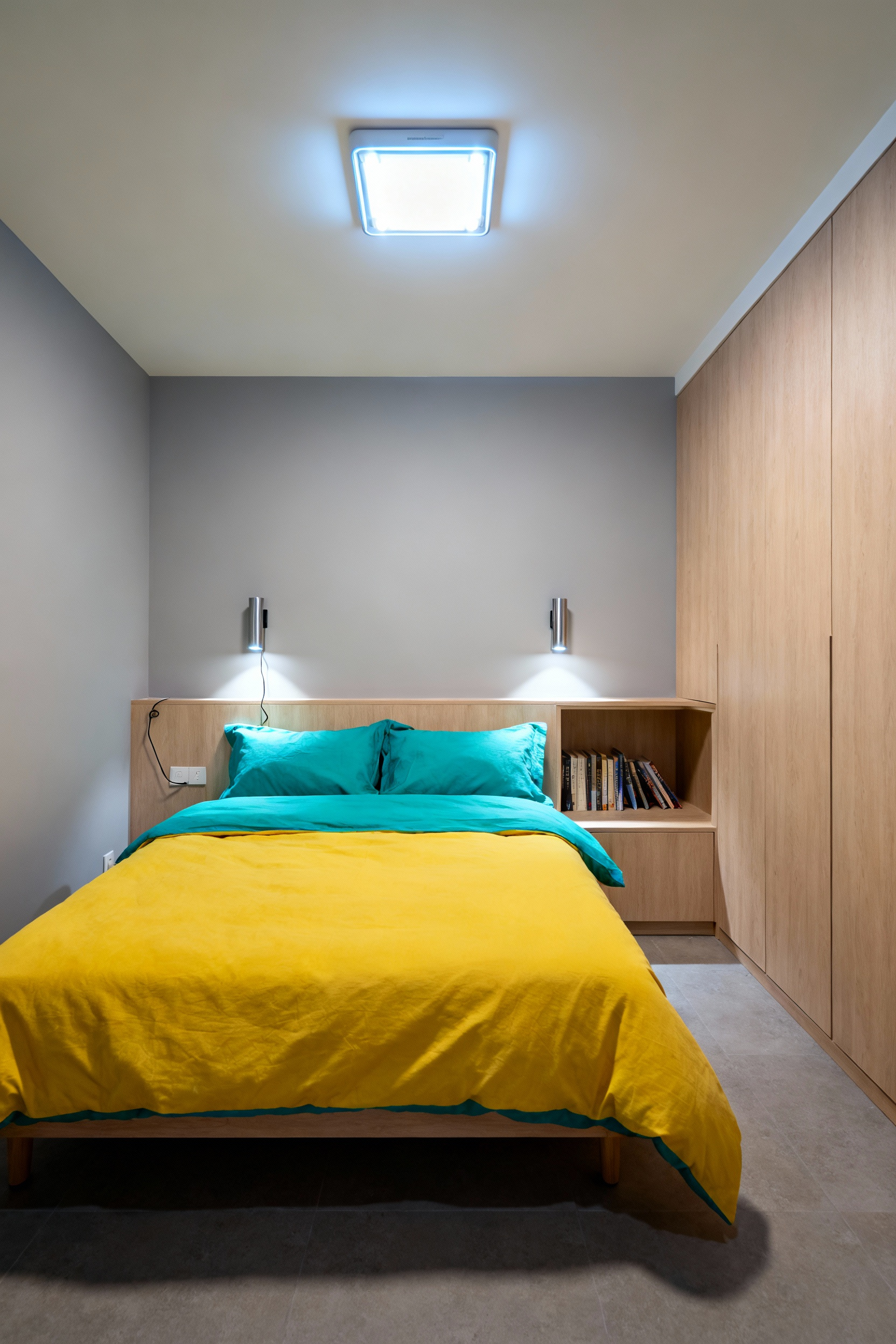 A bright, organized child's bedroom showcasing a layered lighting plan using a ceiling flush-mount fixture for ambient light and wall-mounted sconces for safe task lighting.