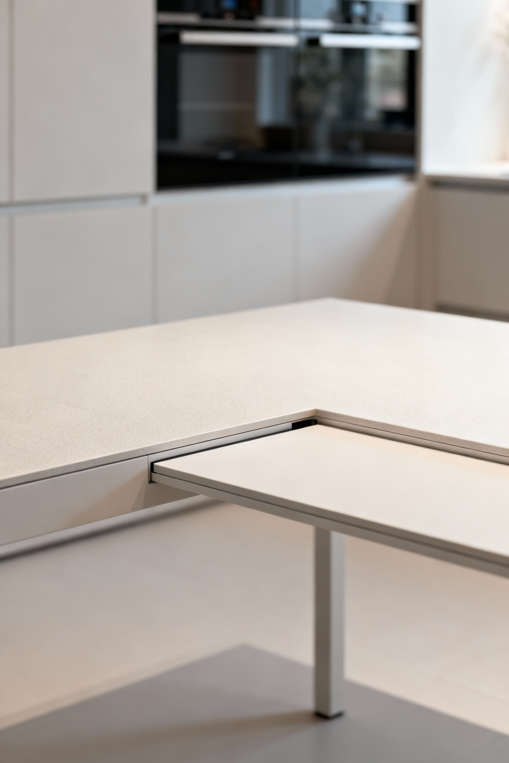A futuristic modular modern kitchen table with an advanced dynamic surface in a minimalist kitchen setting, showing reconfigurable design and innovative materials.
