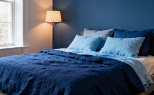 Bedroom with sapphire blue bedding and accent wall, demonstrating psychological impact of blue on serenity.