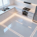 High-angle view of a modern small kitchen floor plan with glowing lines highlighting optimized work zones and efficient spatial flow.