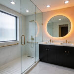 A luxurious modern bathroom featuring a curbless walk-in shower and brushed gold grab bars designed to look like high-end towel racks for stealth accessibility.