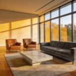 A modern living room with floating furniture ideas featuring a sofa and coffee table centered in the room to create a conversation area.