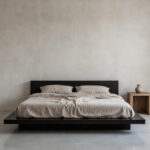 A serene, ultra-minimalist bedroom featuring a low platform bed with linen bedding, textured plaster walls, and soft diffused light, exemplifying the philosophy of aesthetic reduction.